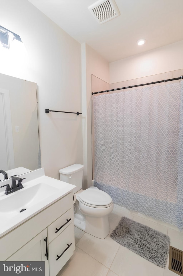 bathroom with toilet, vanity, tile patterned flooring, and a shower with curtain