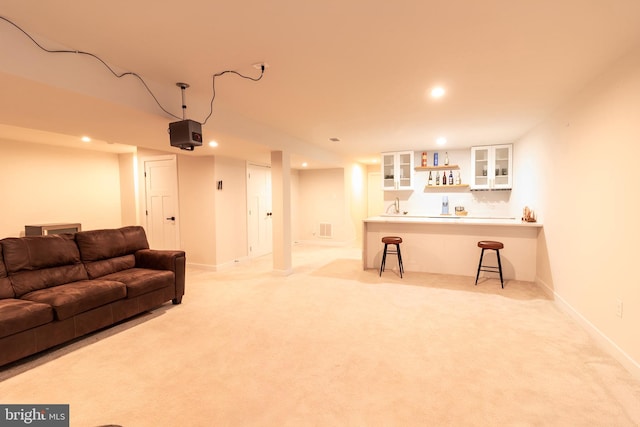 living room with wet bar and light colored carpet