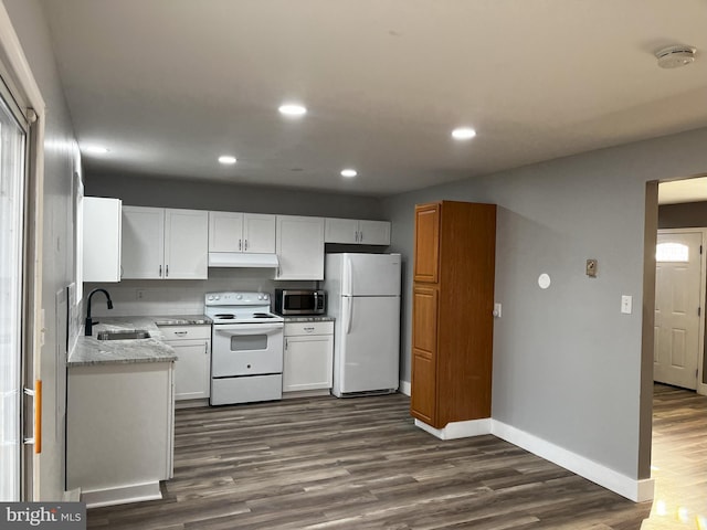 kitchen featuring sink, dark hardwood / wood-style floors, white appliances, light stone countertops, and white cabinets