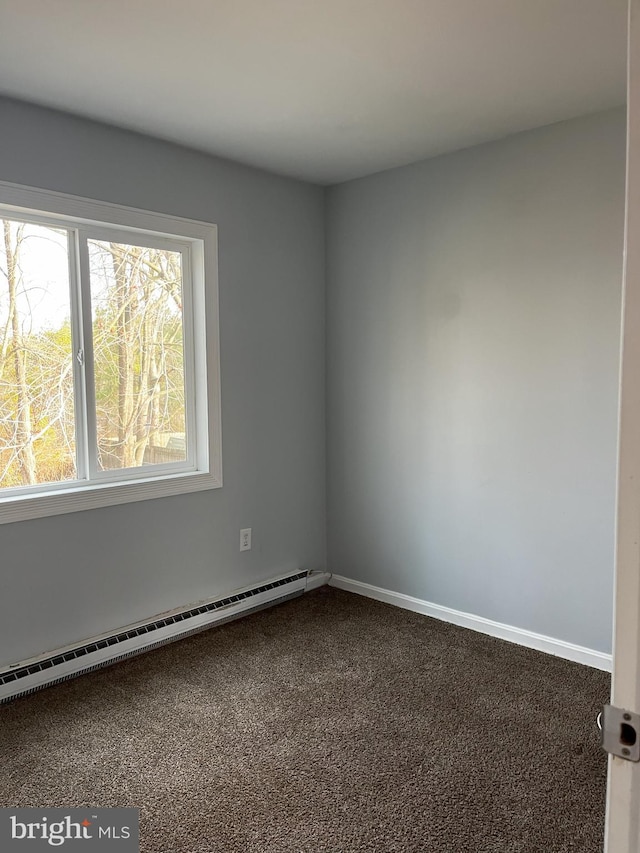 carpeted spare room with baseboard heating