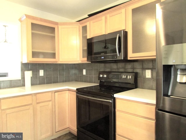 kitchen with pendant lighting, appliances with stainless steel finishes, light brown cabinets, and backsplash