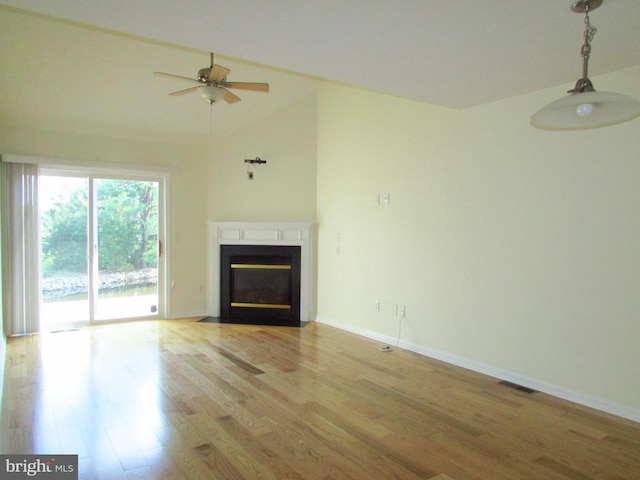 unfurnished living room with vaulted ceiling, ceiling fan, and light hardwood / wood-style flooring