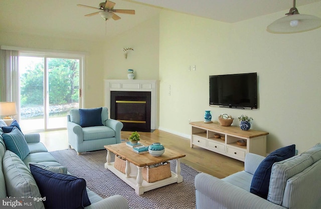 living room with ceiling fan and light hardwood / wood-style floors