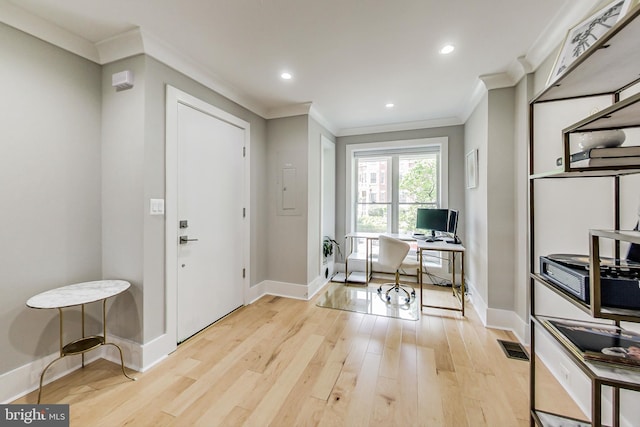 office space with ornamental molding and light hardwood / wood-style flooring