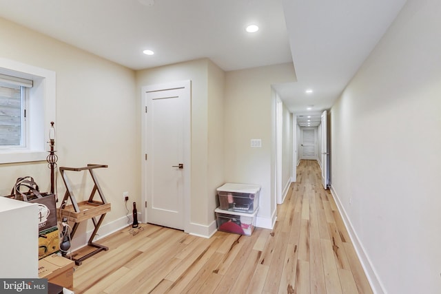 corridor with light hardwood / wood-style floors