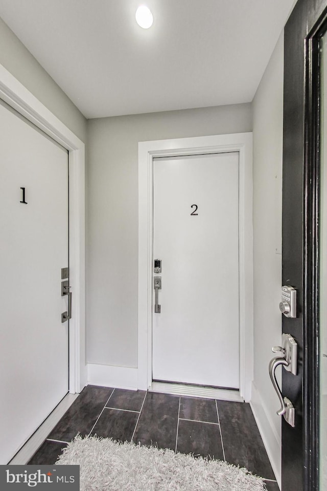 entryway featuring dark tile patterned flooring