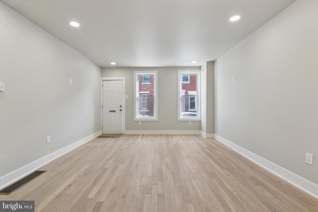 empty room with light hardwood / wood-style flooring