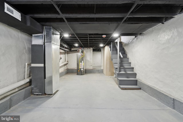 basement with water heater and heating unit