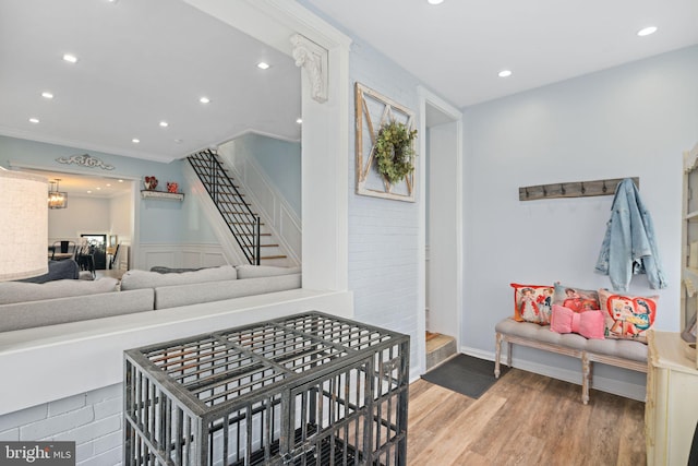 living room with ornamental molding and hardwood / wood-style floors