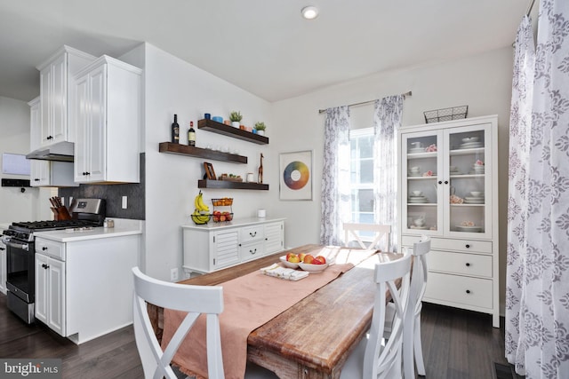 dining space with dark hardwood / wood-style flooring