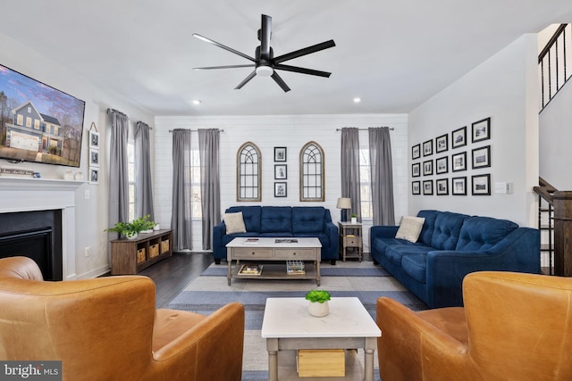 living room with wood-type flooring, a wealth of natural light, and ceiling fan