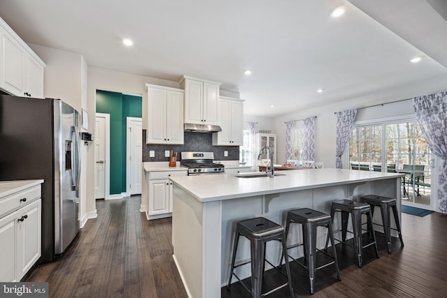 kitchen featuring sink, an island with sink, white cabinets, and appliances with stainless steel finishes