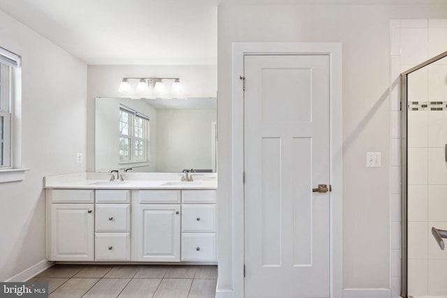 bathroom featuring tile patterned floors, vanity, and an enclosed shower