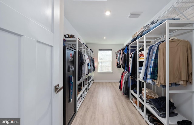 walk in closet featuring hardwood / wood-style flooring