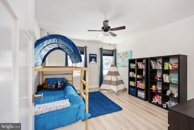 bedroom with ceiling fan and wood-type flooring