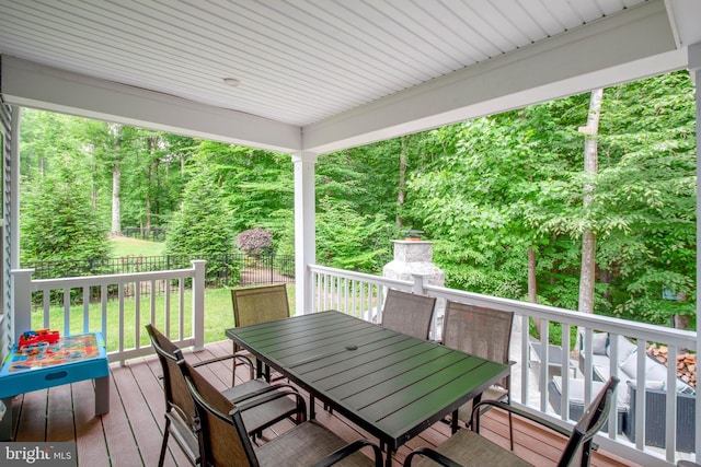 deck featuring a fireplace and a lawn