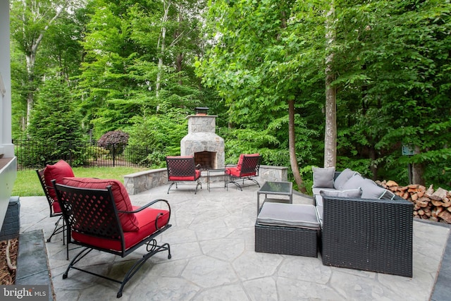 view of patio featuring an outdoor living space with a fireplace