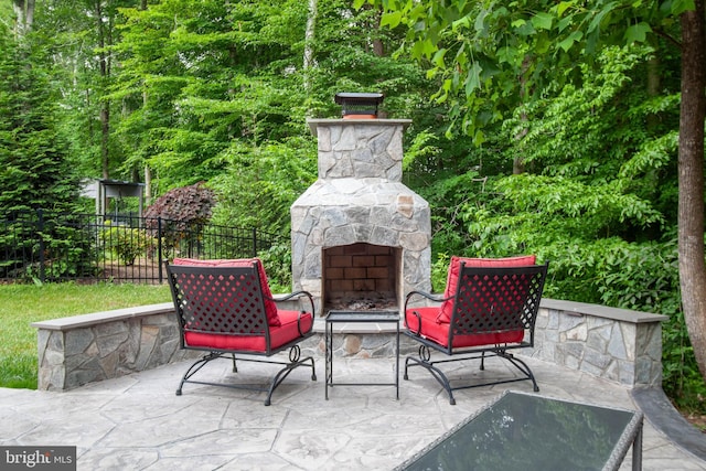 view of patio with an outdoor stone fireplace