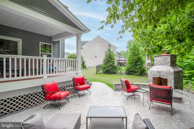 view of patio / terrace featuring an outdoor stone fireplace