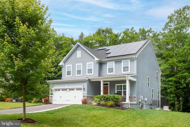 view of front of home with a garage, covered porch, a front lawn, and solar panels