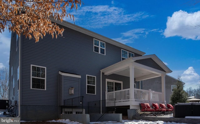 snow covered house with covered porch