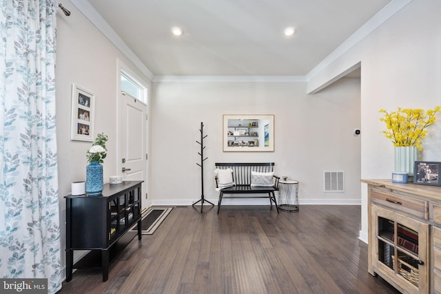 foyer entrance with dark hardwood / wood-style flooring and ornamental molding