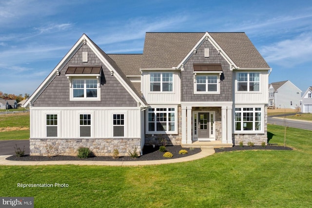 rear view of property featuring a lawn