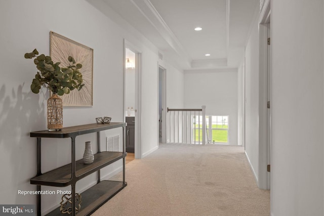 hallway with ornamental molding and carpet floors