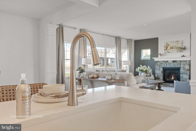 living room featuring a fireplace and sink