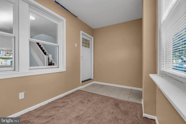 interior space with tile patterned floors, baseboards, and carpet floors