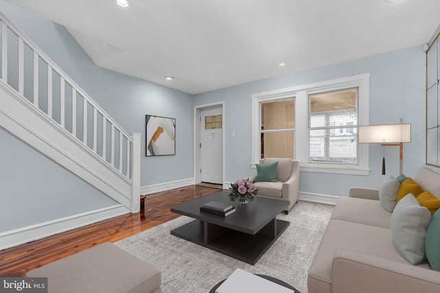 living area featuring stairway, recessed lighting, wood finished floors, and baseboards