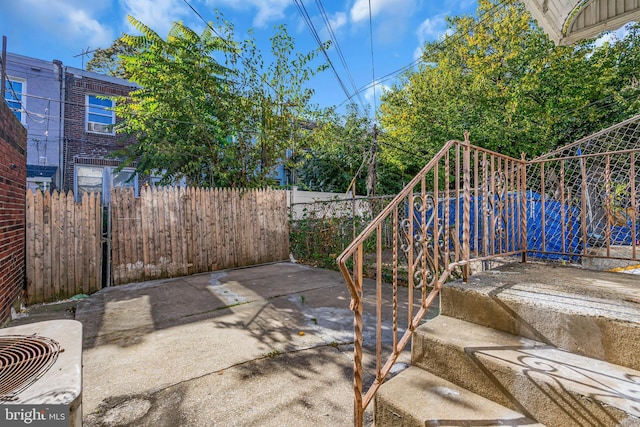 view of patio with central AC and fence