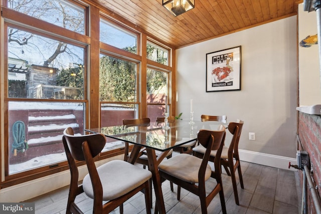 dining space with wood ceiling, crown molding, and hardwood / wood-style floors