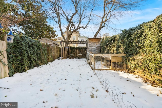 view of yard layered in snow