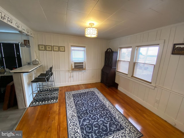 interior space featuring cooling unit, hardwood / wood-style flooring, and plenty of natural light