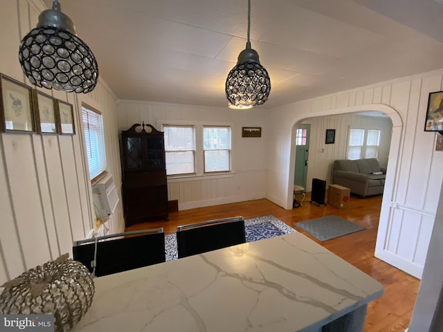 dining space with wood-type flooring