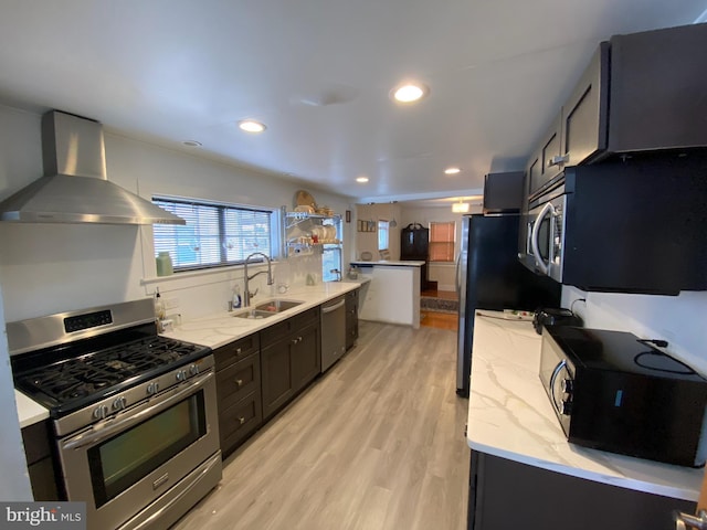 kitchen featuring sink, light hardwood / wood-style flooring, stainless steel appliances, light stone counters, and exhaust hood