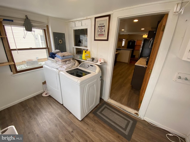 washroom with hardwood / wood-style flooring and washer and dryer