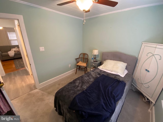 carpeted bedroom featuring crown molding and ceiling fan