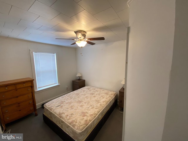 bedroom featuring ceiling fan and dark colored carpet