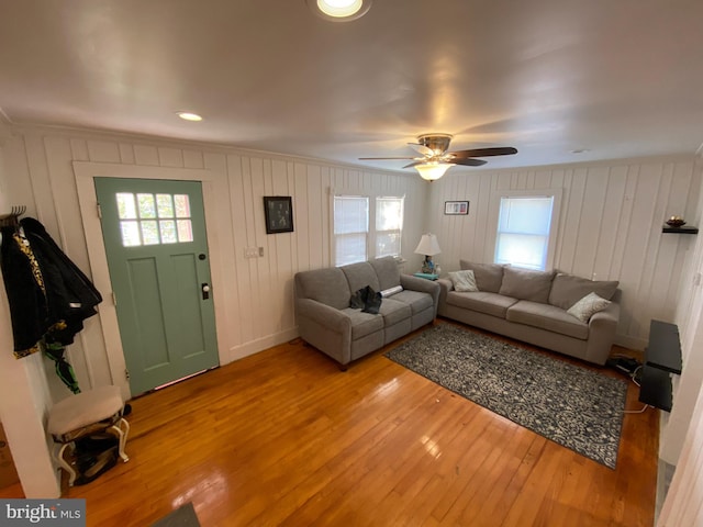 living room featuring light hardwood / wood-style flooring and ceiling fan