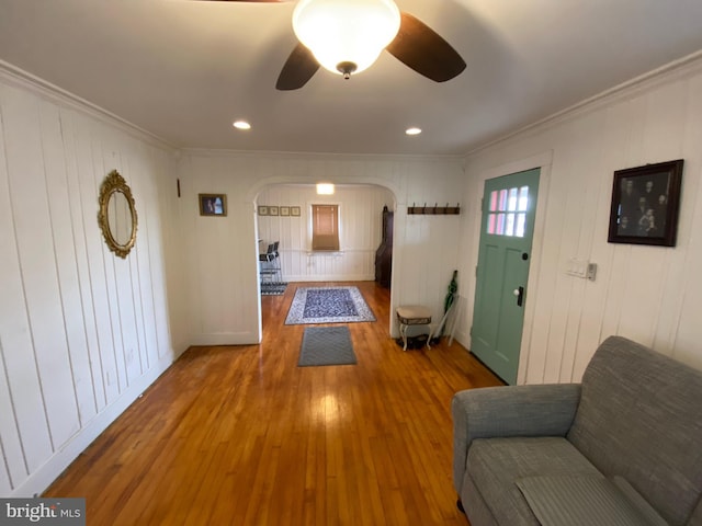 entryway with hardwood / wood-style flooring, ornamental molding, and ceiling fan