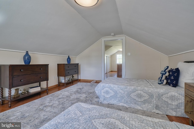 bedroom featuring hardwood / wood-style floors and vaulted ceiling