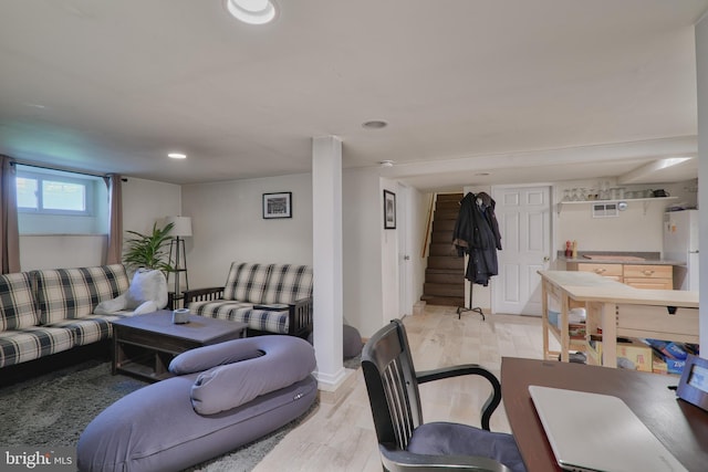 living room with stairs, light wood-type flooring, and recessed lighting