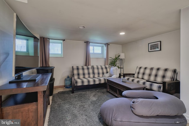 living room with recessed lighting, baseboards, and wood finished floors