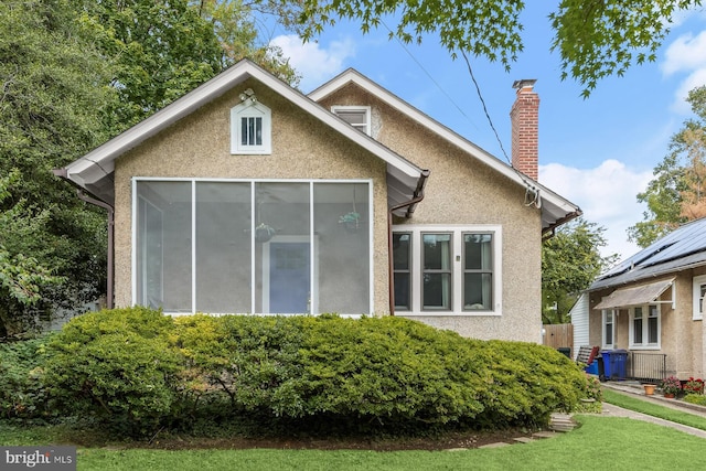 view of home's exterior featuring a chimney and stucco siding