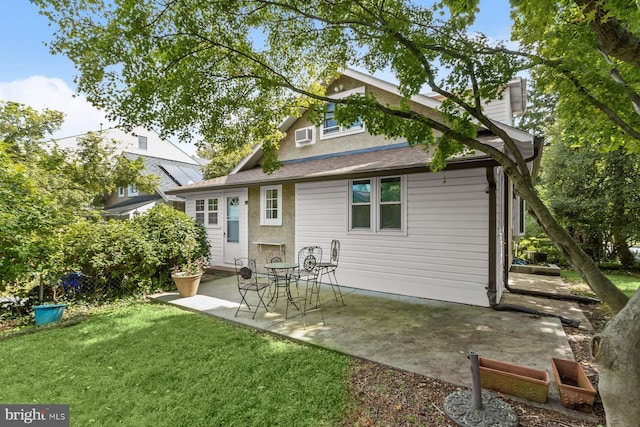 back of house featuring a yard, a chimney, and a patio