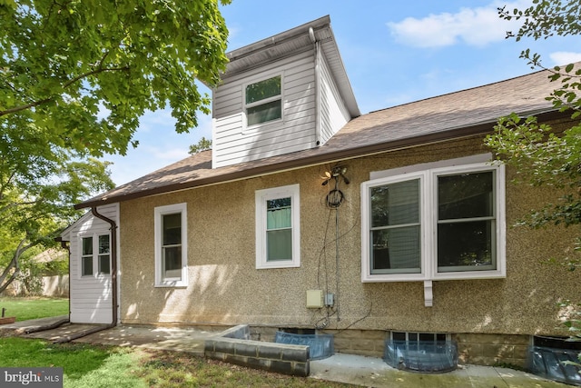 exterior space with roof with shingles