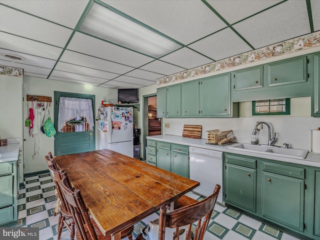 kitchen with white appliances and green cabinetry