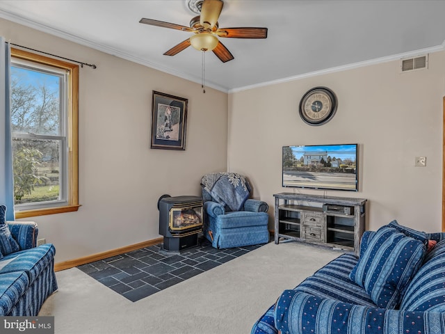 carpeted living room featuring crown molding, ceiling fan, and a wood stove